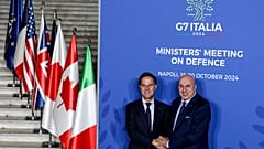 Italy's Defense Minister Guido Crosetto, right, welcomes NATO Secretary General Mark Rutte at the G7 Ministers' Meeting on defense in Naples, Italy, Saturday, Oct. 19, 2024.