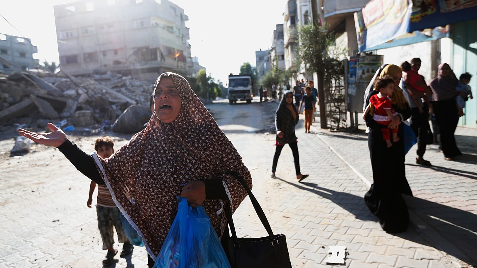 فلسطينيون يفرون من منازلهم في حي الشجاعية في مدينة غزة، بعد أن ألقت إسرائيل منشورات تحذر الناس من مغادرة المنطقة، الأربعاء، 16 يوليو 2014
