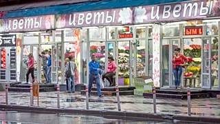 FILE: Street shops vendors wait for customers at their flowers shops in Moscow, 27 July 2015