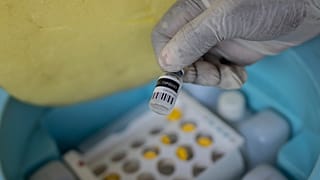 A nurse holds a bottle of mpox vaccine in the Democratic Republic of Congo in October 2024.
