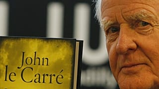 John le Carre holds a copy of his new book entitled 'Our Kind of Traitor' in 2010