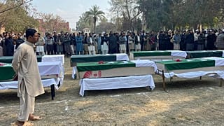 صورة أرشيفية لأشخاص يحضرون صلاة الجنازة على ضباط الشرطة الذين قُتلوا في هجوم شنته طالبان على مركز للشرطة في ديرا إسماعيل خان، باكستان