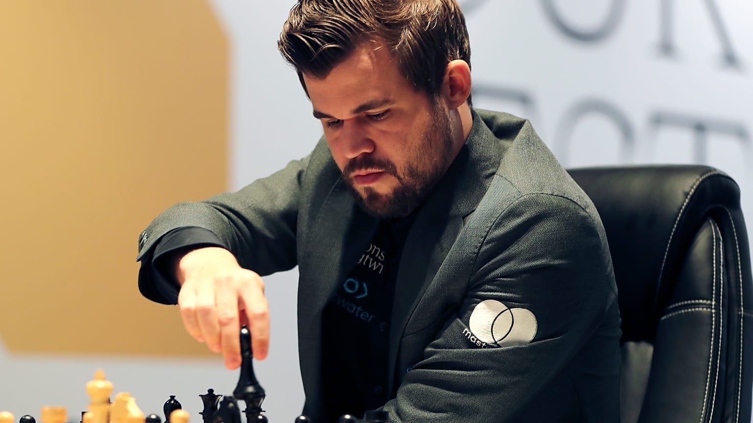 Norway's World Chess Champion Magnus Carlsen, makes a move against Ian Nepomniachtchi of Russia, during their Game One of the FIDE World Championship at the Dubai Expo, 2021