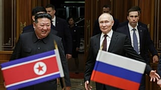 Russian President Vladimir Putin, right, and North Korea's leader Kim Jong Un smile during their meeting at the Pyongyang Sunan International Airport in North Korea.