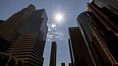 The sun shines over the financial district towers of downtown Los Angeles during a heatwave Friday, Sept. 6, 2024, in Los Angeles