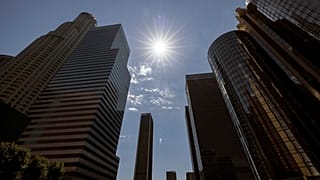 The sun shines over the financial district towers of downtown Los Angeles during a heatwave Friday, Sept. 6, 2024, in Los Angeles