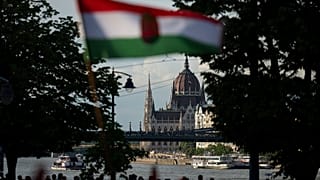 eople wave a Hungarian national flag next to the Danube river, in Budapest, Thursday May 30, 2024,