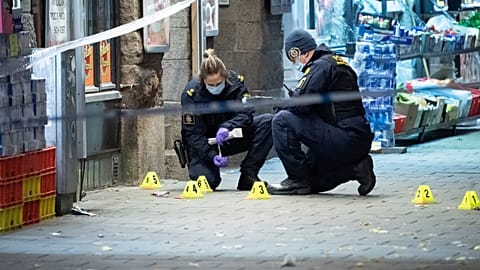 Police officers work near the scene of a shooting, in Malmo, Sweden. 