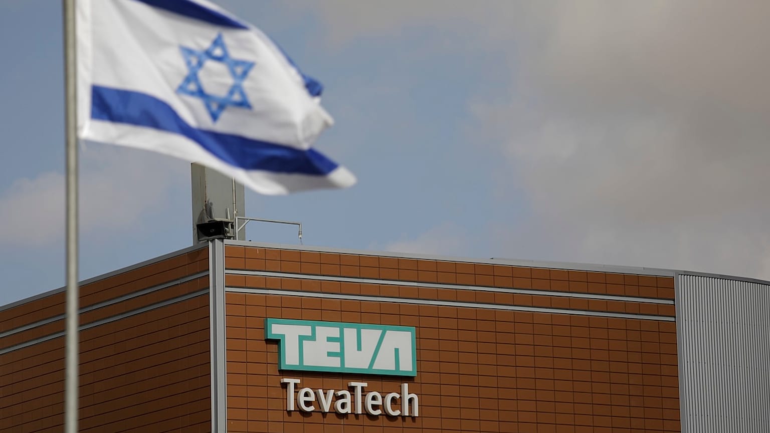 Israeli flag flies outside Teva Pharmaceutical facility building in Neot Hovav, Israel