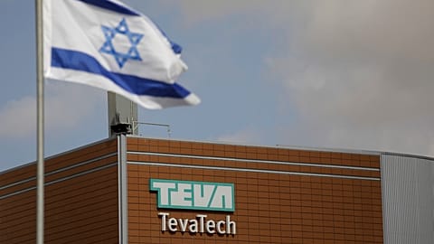 Israeli flag flies outside Teva Pharmaceutical facility building in Neot Hovav, Israel