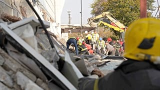 Rescue workers search for victims in the aftermath of an outdoor roof collapsed at a train station in Novi Sad, 1 November 2024