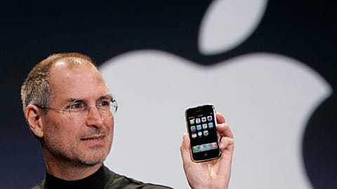 FILE - Apple CEO Steve Jobs holds up an Apple iPhone at the MacWorld Conference, Jan. 9, 2007, in San Francisco. 