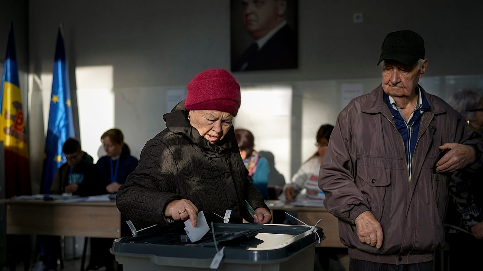 A woman prepares to cast her vote during a presidential election runoff, in Chisinau, Moldova, Sunday, Nov. 3, 2024.
