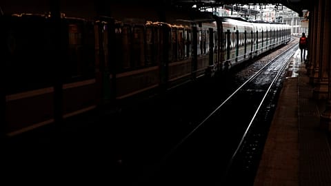 A passenger stands on empty platform of a RER suburb subway, in Paris, Dec. 8, 2019.