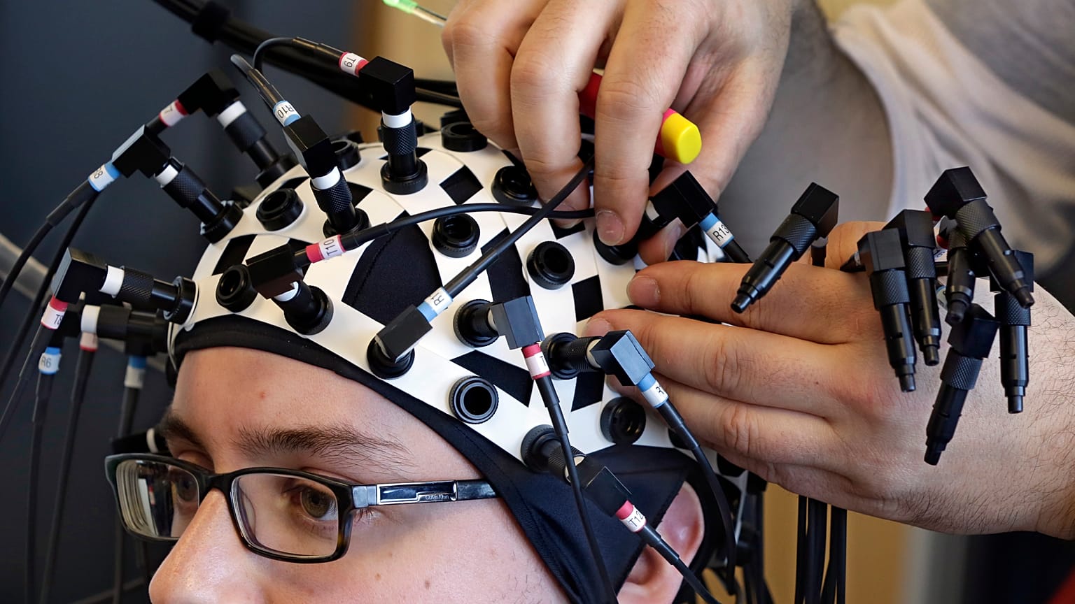 A researcher at the Yale Brain Function Lab has laser probes attached to his head during a demonstration of brain mapping technology in 2015