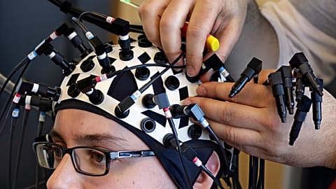 A researcher at the Yale Brain Function Lab has laser probes attached to his head during a demonstration of brain mapping technology in 2015
