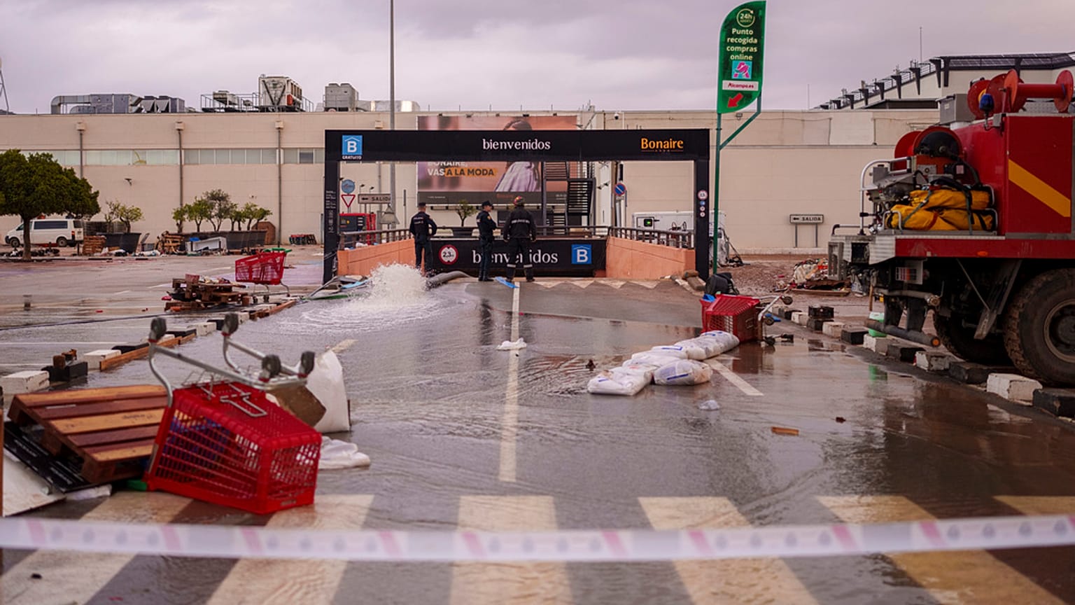 عمال الإنقاذ يضخون المياه في ساحة موقف السيارات تحت الأرض في مركز التسوق في ألدايا بإسبانيا 
