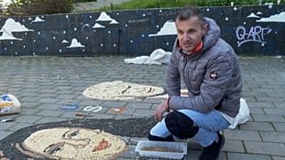Pozhegu creating the mosaic on the ground