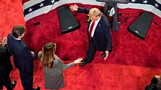 Republican presidential nominee former President Donald Trump walks over to hug former first lady Melania Trump as their son Barron looks on