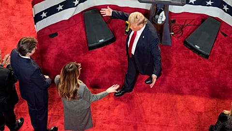 Republican presidential nominee former President Donald Trump walks over to hug former first lady Melania Trump as their son Barron looks on