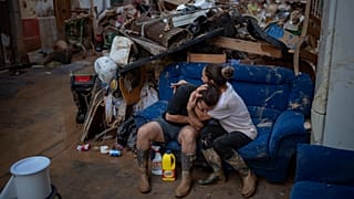 Tania hugs her brother-in-law Baruc after rescuing some of their belongings from their flooded house after the floods in Paiporta, Valencia, Spain, Tuesday, Nov. 5, 2024. 