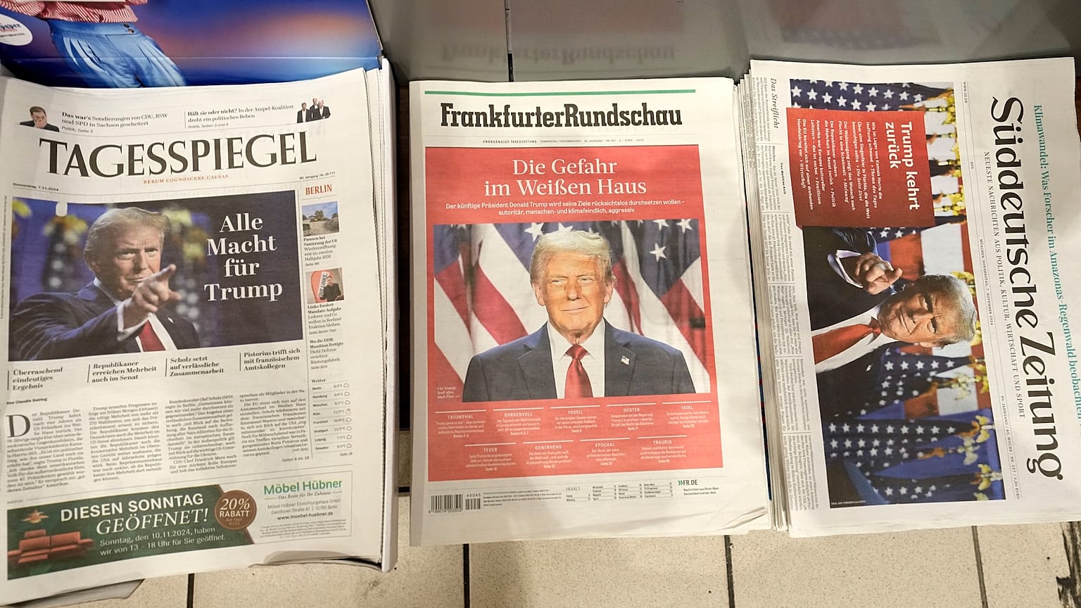 German newspapers front-pages with President-elect Donald Trump are seen at a station kiosk in Cologne, Germany