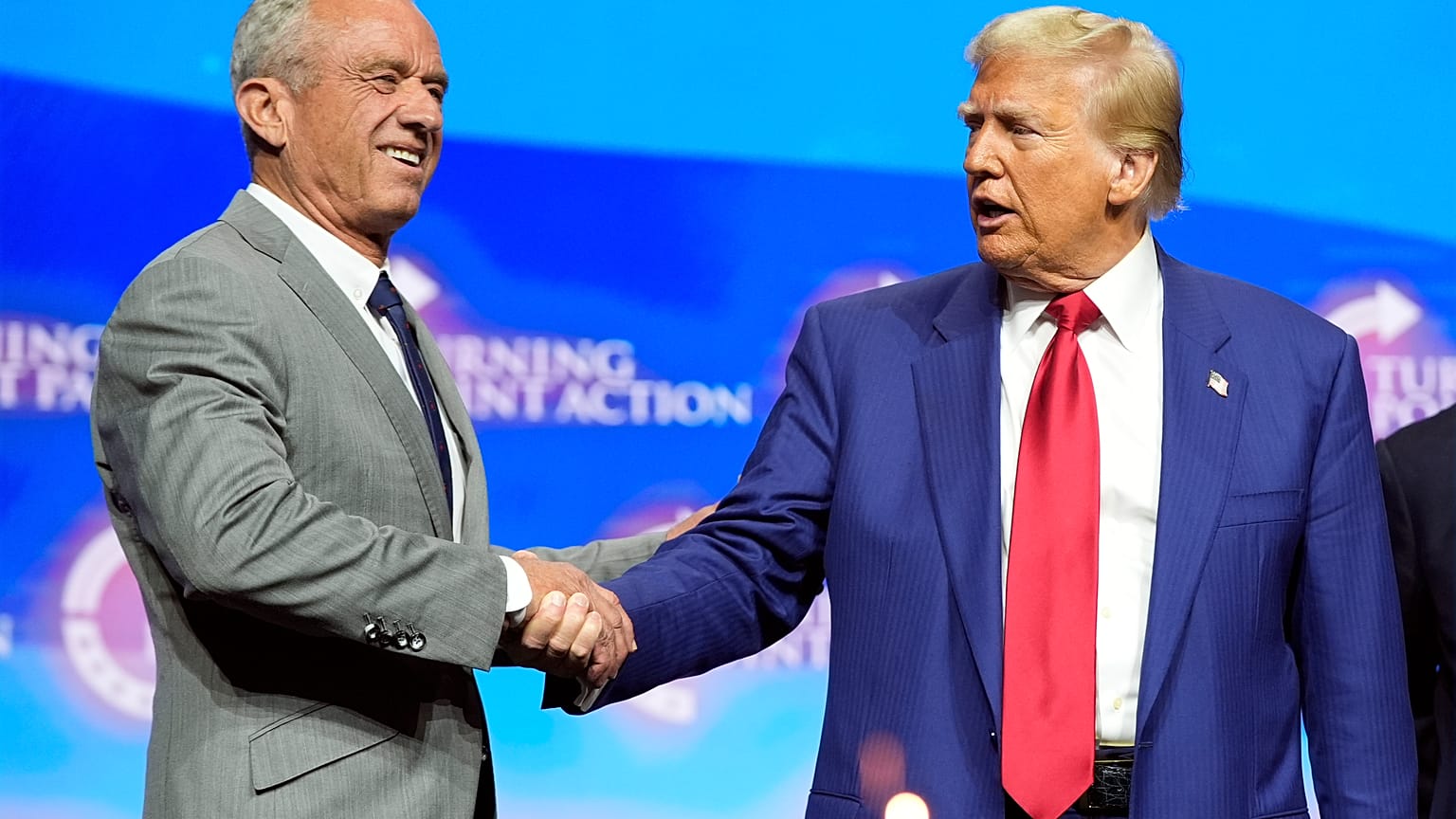 Donald Trump shakes hands with Robert F. Kennedy Jr. at a campaign rally in Georgia in October 2024.