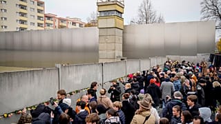 People attend a flower laying ceremony on occasion of the 35th wall anniversary at the grounds of the Berlin Wall Memorial, Berlin, Germany, Saturday, Nov.9, 2024. (AP Photo)