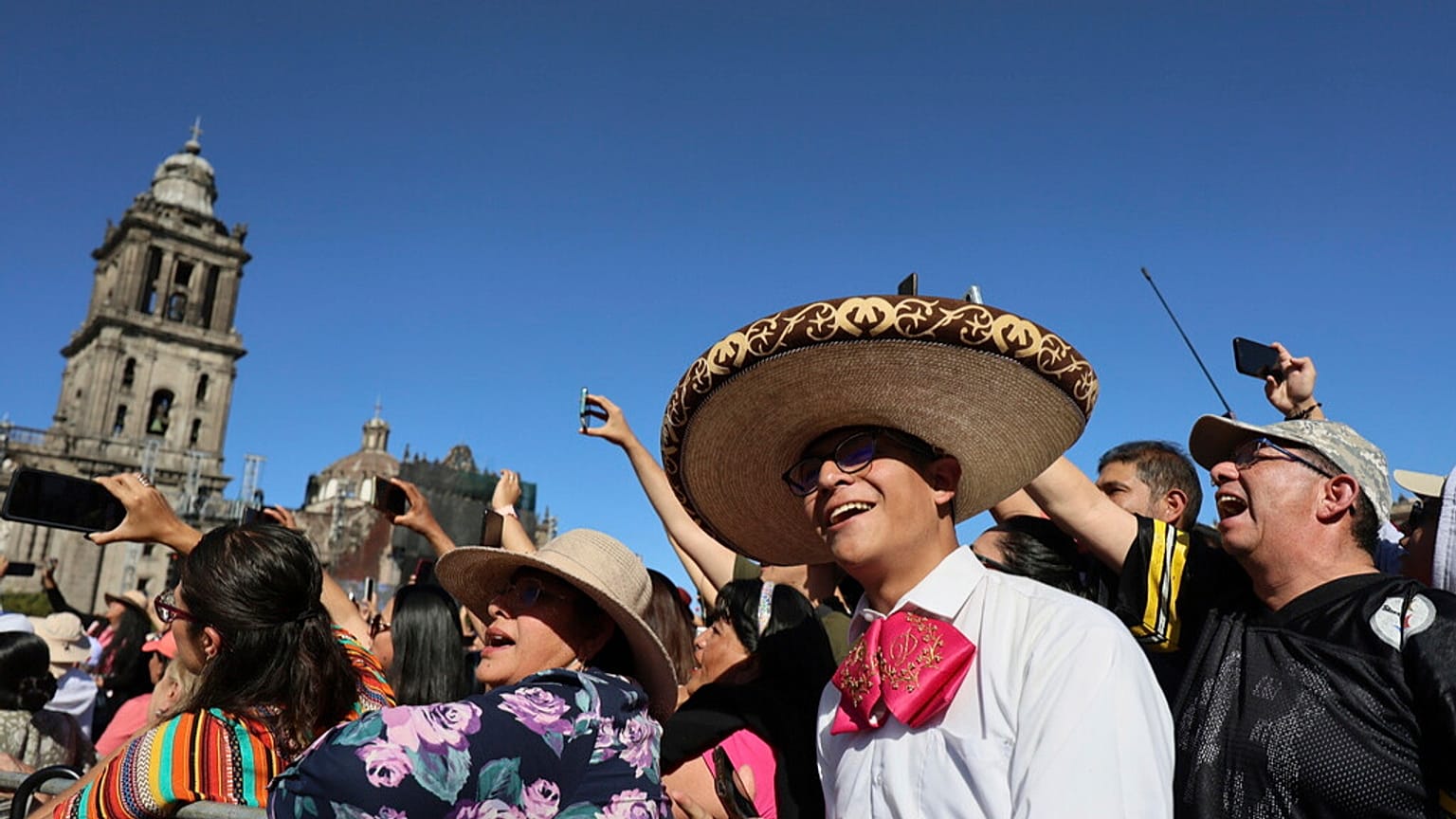 People sing with musicians who gathered to break the record of most mariachis performing in unison, at the Zocalo, Mexico City's main square, Sunday, Nov. 10, 2024.