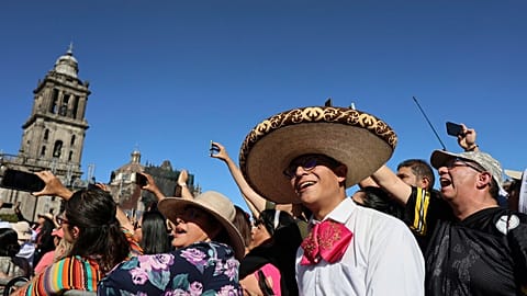 People sing with musicians who gathered to break the record of most mariachis performing in unison, at the Zocalo, Mexico City's main square, Sunday, Nov. 10, 2024. 