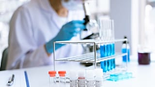 Medical research scientist working with a microscope to do research