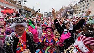 Costumed revelers celebrate at the central Heumarkt while tens of thousands of carnival fools take to the streets of Cologne, Germany, Monday, November 11, 2024