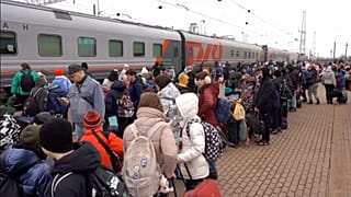 children deported from Ukraine board a train to relocate to Russia