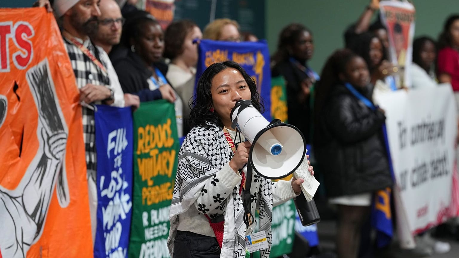 Activists participate in a demonstration calling for climate finance at COP29, 14 November.