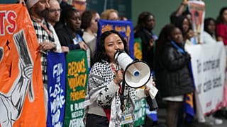 Activists participate in a demonstration calling for climate finance at COP29, 14 November.