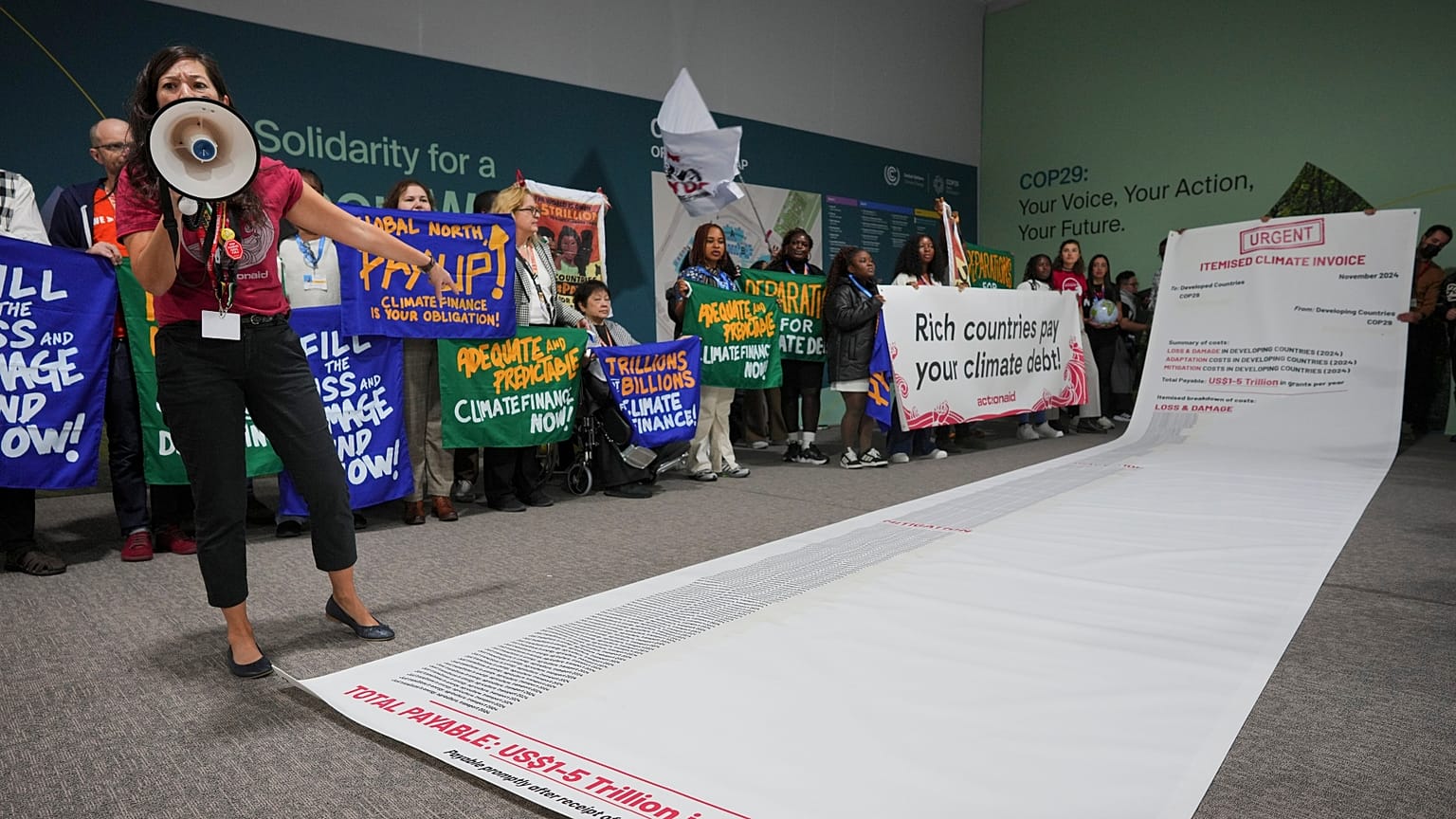 Activist Teresa Anderson leads a demonstration calling for climate finance during COP29.
