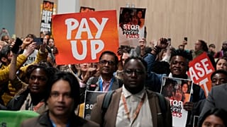 Activists participate in a demonstration for climate finance at COP29.