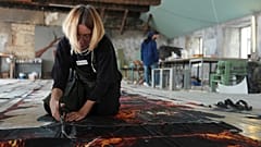 Anna Varszegi, of Budapest, Hungary, works on preparations for a demonstration during COP29.