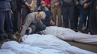 Men mourn over the bodies of victims from an Israeli airstrike before their funeral outside a hospital in Deir al-Balah, Gaza, Sunday Nov. 17, 2024. 