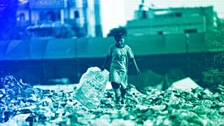 A Palestinian kid sorts through trash at a landfill in Zawaida, Gaza Strip, November 2024