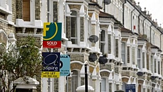 Library picture of estate agents' notices in south London