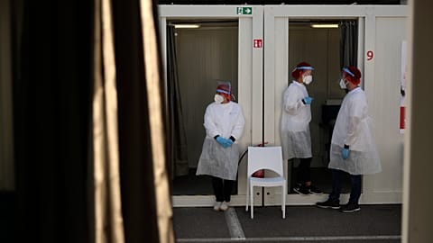 Medical workers wait to administer COVID-19 tests in Belgium in 2020.