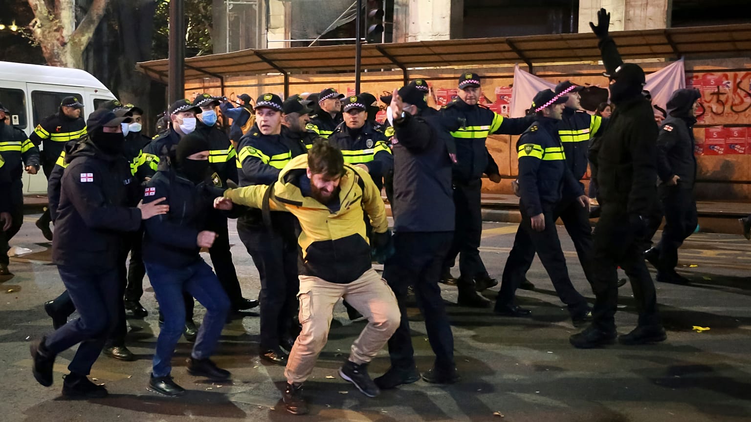 Police detain a protester in a street during a rally against the results of the parliamentary elections amid allegations that the vote was rigged in Tbilisi, Georgia, Tuesday.