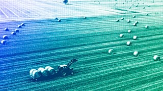 A farmer harvests his field at the Harz mountains near Wernigerode, July 2022