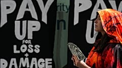 Activist Melike Futtu participates in a demonstration for climate finance at COP29. 