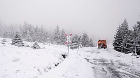 A truck drives along an icy road.
