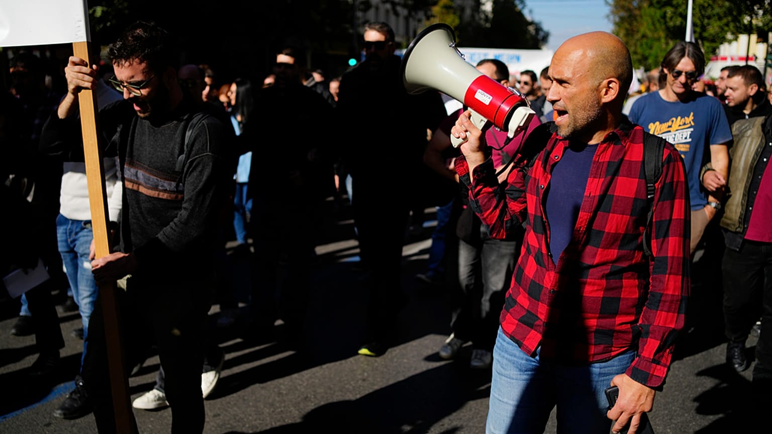 Protesters take part in rally, during a nationwide general strike organized by private and public sector unions demanding for better wages, in Athens, Wednesday, Nov. 20