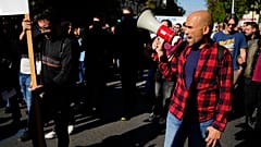 Protesters take part in rally, during a nationwide general strike organized by private and public sector unions demanding for better wages, in Athens, Wednesday, Nov. 20
