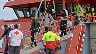 Migránsok szállnak le a hajóról