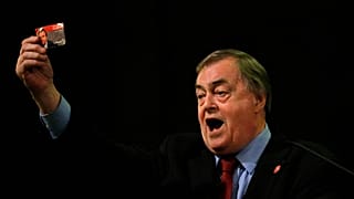 Former Deputy leader of the Britain's Labour Party, John Prescott, holds up his Labour Party membership card in London, 24 August 2015.